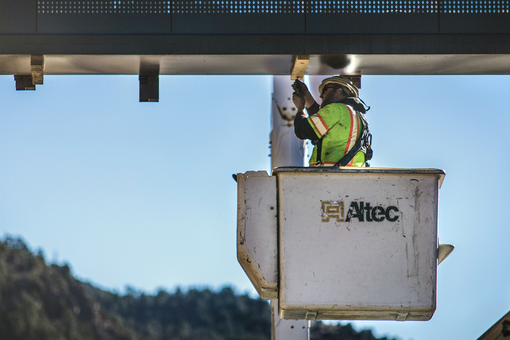 worker lifted for billboard installation