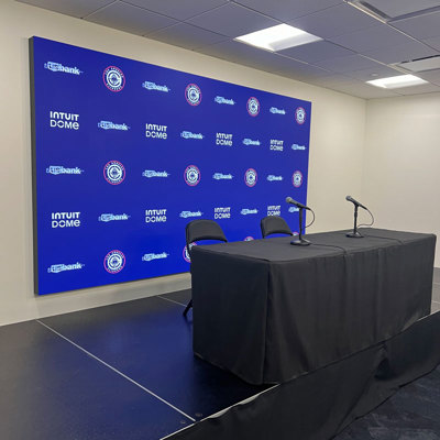 LED backdrop behind Intuit Dome press table