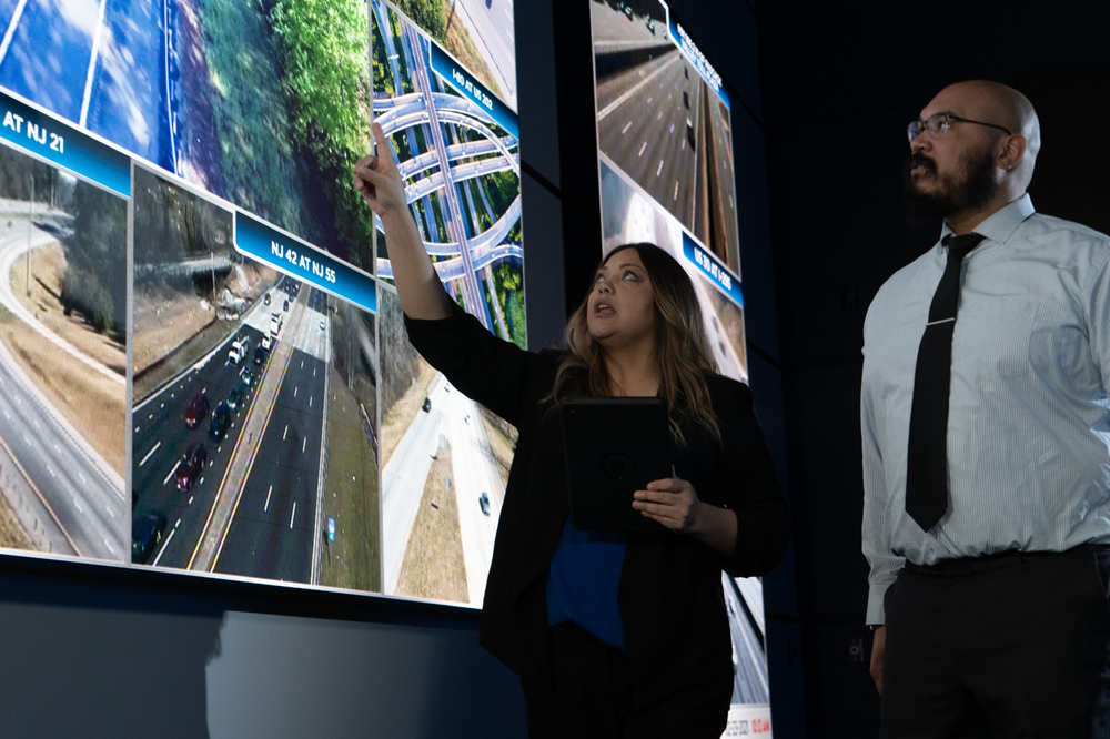 workers in a TMC looking at LED displays