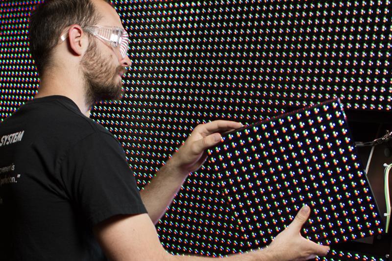 installation tech placing LED modules