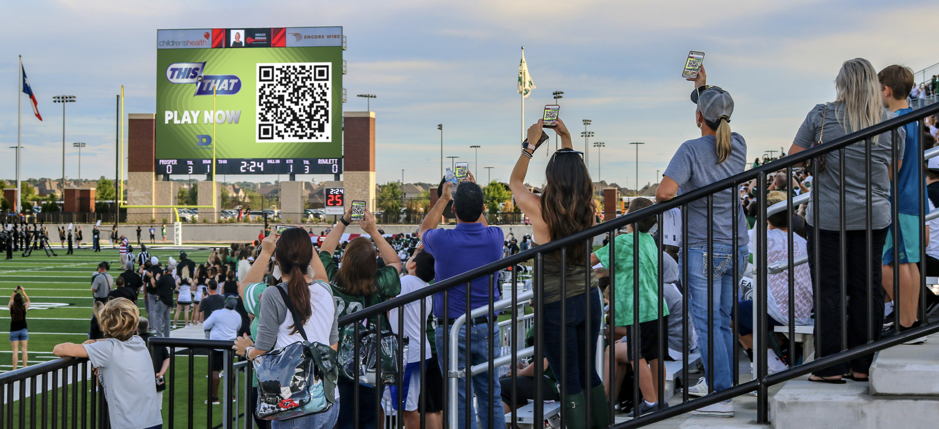 Crowd scanning qr code on video board