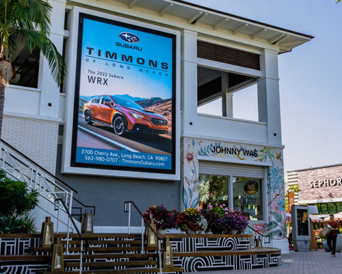 Retail store with large video display along outside wall